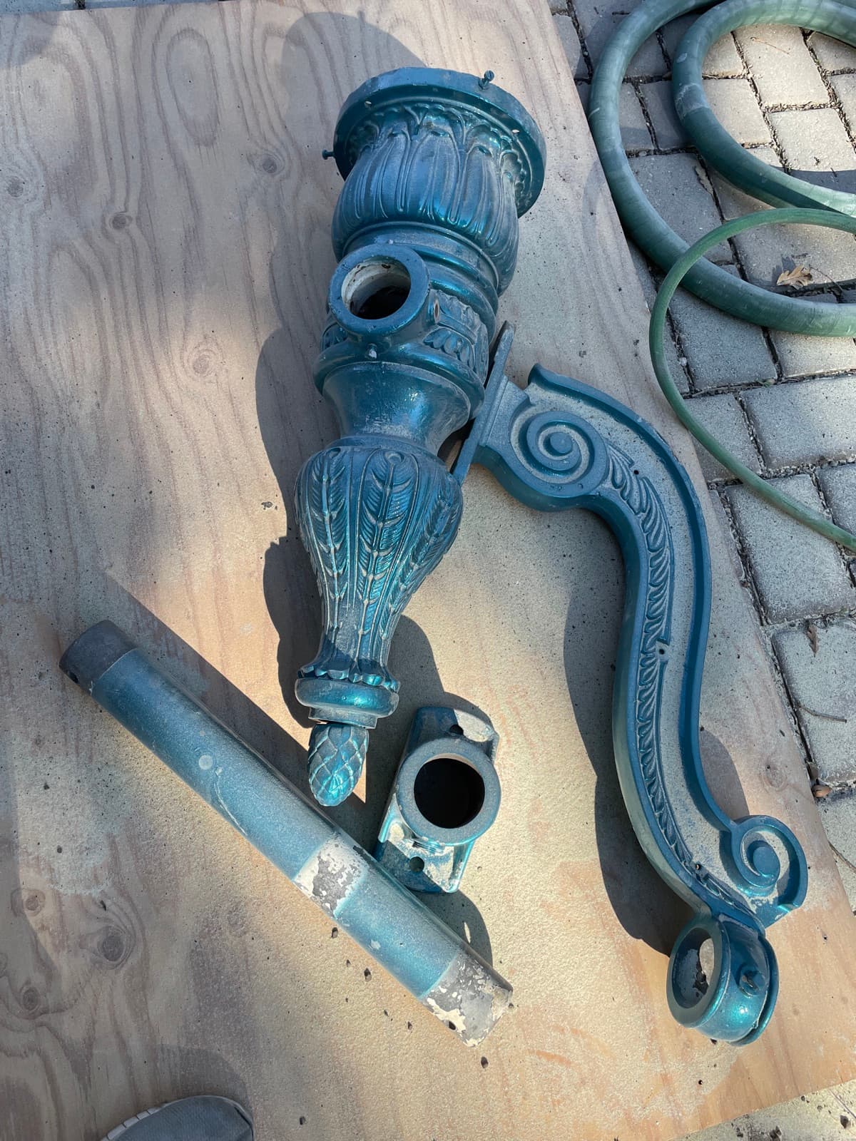 Ornate lamp post parts after blasting
